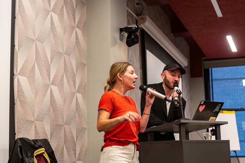 Nicole presenting on stage at a live AI training event